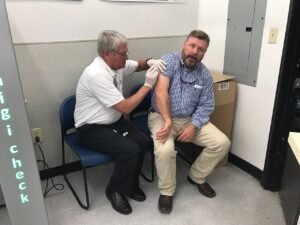 Persona recibiendo una vacuna contra la influenza, similar a la campaña invernal de Nuevo León.